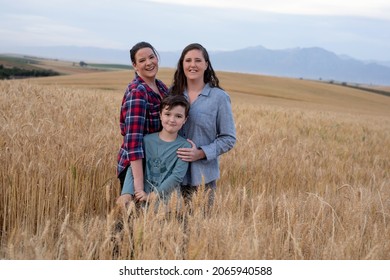 Lesbian Moms With A Young Boy. In A Wheat Field In The Country. 