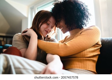 Lesbian Women Caressing On The Couch. Homosexual Girl Couple Flirting On The Sofa. Gender Equity Concept.