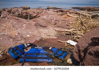 Lesbos, Greece - April 13th, 2018: A Life Vest Used By Refugees Can Be Seen On The Shore. Migrant Crisis In Lesvos