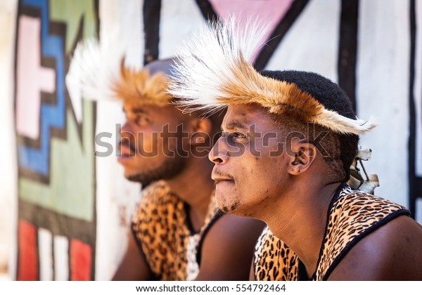 LESEDI CULTURAL VILLAGE, SOUTH\
AFRICA - NOVEMBER 4, 2016. Two young male Zulu tribe members\
wearing traditional warrior leopard skin garments and\
headdresses
