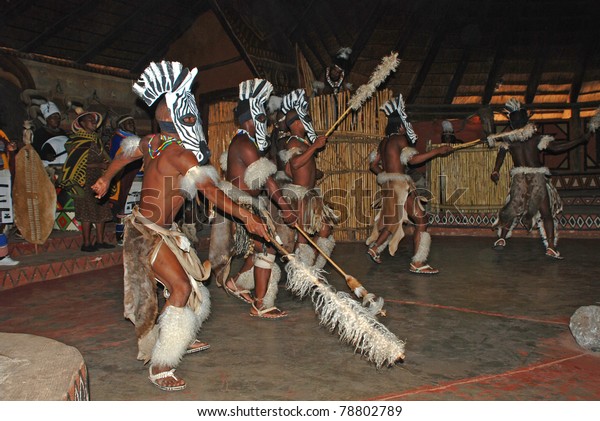 LESEDI VILLAGE, SOUTH AFRICA - DECEMBER 01: A\
group of South African Zulu dancers in ritual costumes entertaining\
 for  tourists on December 01, 2008 at the Cultural Village Lesedi,\
South Africa.