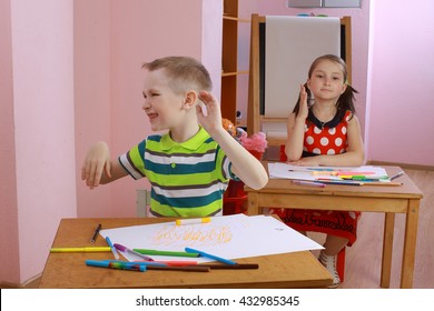 A Lesson In Class With A Hyperactive Child. Hyperactive Boy. The Child Indulges In The Classroom. Misbehaves. Teacher Talking To Student. The Boy Waved His Hands And Turning His Head. Hyperactive Boy