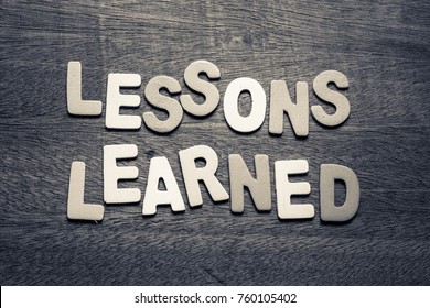 Lesson Learned by wood letters on wood background