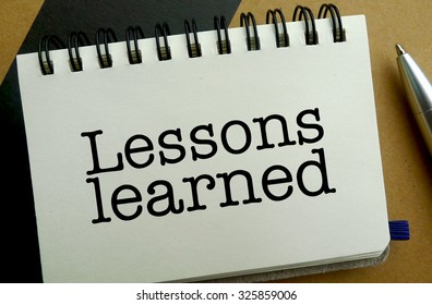 Lesson learned memo written on a notebook with pen