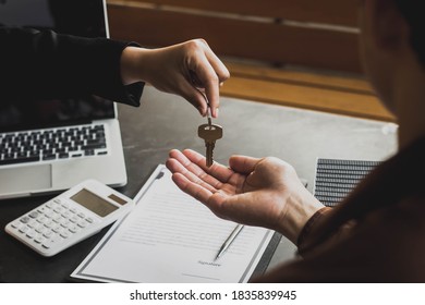 The Lessor Is Handing Over The Keys To The Tenant. Concept Of Purchasing New Apartment.