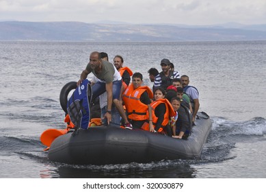 LESVOS, GREECE  SEPTEMBER 24, 2015: Refugees arriving in Greece by  boat from Turkey.  These Syrian refugees land their boat near Molyvos, Lesvos. Turkey can be seen in the background.