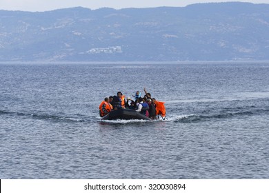 LESVOS, GREECE SEPTEMBER 24, 2015: Refugees arriving in Greece by  boat from Turkey.  These Syrian refugees land their boat near Molyvos, Lesvos. Turkey can be seen in the background.