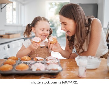 Let Do A Taste Test. Shot Of A Woman Baking With Her Daughter At Home.