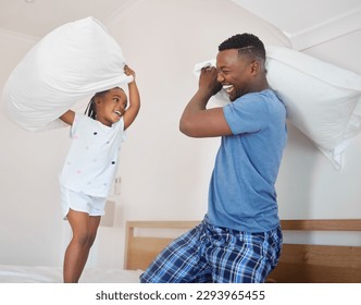 Let the fun begin. Shot of a father and his daughter having a pillow fight together at home. - Powered by Shutterstock