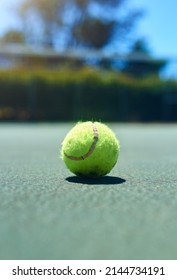 Let the games begin. Cropped shot of a tennis ball on an empty court during the day.