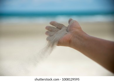 Let it go, Freedom hand , and Release concept. Hand let go of woman release sand on beautiful sea beach and blue water background