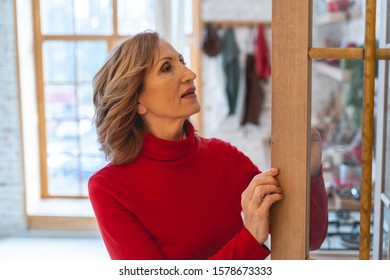 Let Me Check. Beautiful Brunette Female Standing In Semi Position And Looking For Her Favorite Things