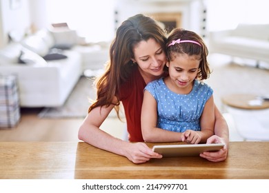 Let Me Give You A Tour Online Mom. Cropped Shot Of Mother And Daughter Using A Digital Tablet Together At Home.