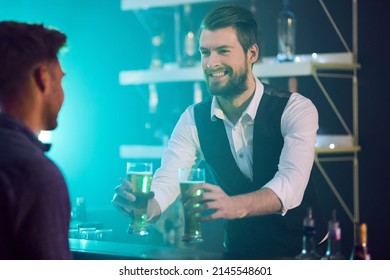 Let Me Know If I Can Get You Anything Else. Cropped Shot Of A Bartender Serving Drinks To A Man In A Nightclub.