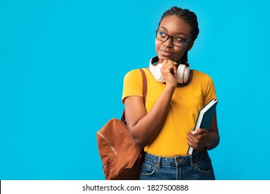 Let Me Think. Thoughtful African American Woman Student Thinking Holding Books Standing On Blue Studio Background. College Education, Study, Student's Thoughts Advertisement. Free Space For Text