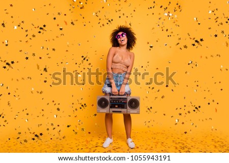 Let the party start! Full-length of playful crazy funny excited cheerful with bronze skin patrybotch is holding retro old-fashioned boombox, organizing a party, isolated on yellow background