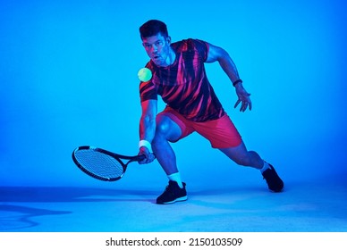 Let The Racket Do The Talking. Blue Filtered Shot Of A Tennis Player In The Studio.