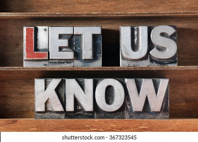 let us know phrase made from metallic letterpress type on wooden tray