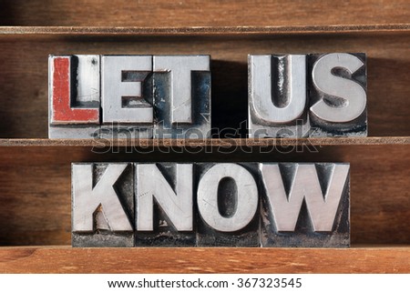 let us know phrase made from metallic letterpress type on wooden tray