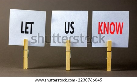 Let us know symbol. Concept words Let us know on white paper on a beautiful grey table grey background. Business and let us know concept. Copy space.