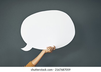 Let Your Message Be Seen And Heard. Studio Shot Of An Unrecognisable Woman Holding A Speech Bubble Against A Grey Background.