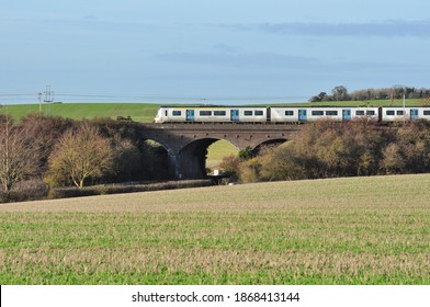 LETCHWORTH, HERTFORDSHIRE, UK - December 1, 2020. Suburban Train Class 700 EMU No 700052 Crossing Road Bridge In Countryside, Hertfordshire, England, UK