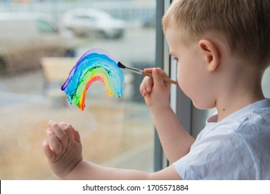 Let's All Be Well. Child At Home Draws A Rainbow On The Window. Flash Mob  Chasetherainbow On Self-isolation Quarantine Pandemic Coronavirus.