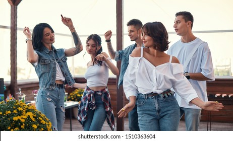 Let's Dance Group Of Happy Friends Enjoying Party On Rooftop Terrace