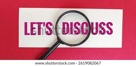 Let's Discuss text under magnifying glass on piece of paper on red background, concept of communication, focus, analysis, discussion, and conversation in business.