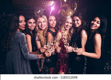
Lets drink for success! Beautiful young women in evening gown holding champagne glasses and looking at camera with smile while celebrating in nightclub
 - Powered by Shutterstock