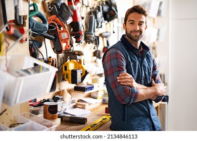 Lets fix it. Portrait of a handsome young handyman standing in front of his work tools.