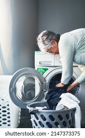 Lets Get Down To Laundering Business. Shot Of A Mature Woman Doing Laundry At Home.