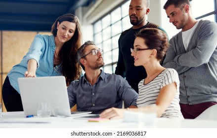 Lets get everyones input on this. Shot of a group of coworkers having a meeting in an open plan office.