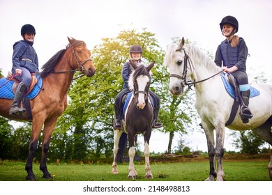 Lets Get Ready To Ride. Shot Of A Group Of Teenage Girls Going Horseback Riding Together.