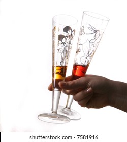 Let'S Get Some More Pair of red and gold champagne flutes almost empty held by hand. Isolated on white space (for text).