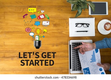 LET'S GET STARTED Businessman Working At Office Desk And Using Computer And Objects, Coffee, Top View, With Copy Space