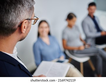 Lets Get Started. Shot Of A Mature Businessman Calling In The Next Candidate For A Job Interview In A Modern Office.