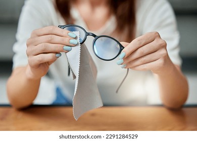 Lets get them crystal clear. an unrecognizable person cleaning glasses at home.
