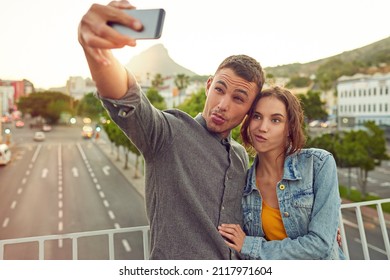 Lets Get Weird. Shot Of A Happy Young Couple Taking A Selfie Together In The City.