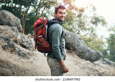 Lets go on a adventure. Portrait of a cheerful young man wearing a backpack and ready to hike up a mountain. - Powered by Shutterstock