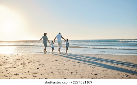 Lets go splish and splash. Rearview shot of a happy family walking towards the sea. - Powered by Shutterstock