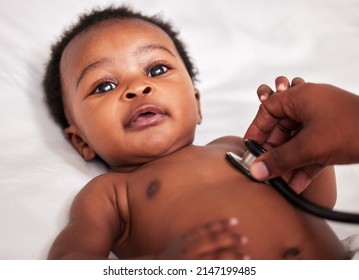 Lets Listen To Your Little Heart. Shot Of A Little Baby At A Checkup With A Doctor At A Clinic.