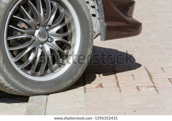 Let\'s\
meet a part of the car, parked on the\
sidewalk,