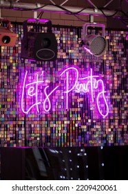 Lets Party Neon Light Up Sign On Dance Floor Part For Wedding First Dance.  Purple Text.