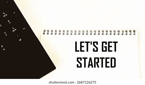 Let's start with the text on the notepad next to the laptop