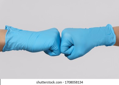 Let's Work Together! Battle Against Coronavirus. Two Medical Workers Making A Fist Bump Gesture. 