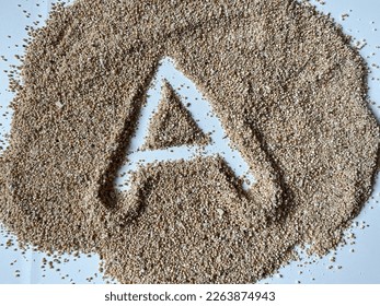 Letter A of alphabeth written on sand with uppercase