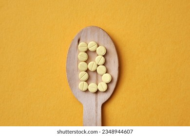 The letter B on a wooden spoon. Vitamin B in food, vitamin B deficiency