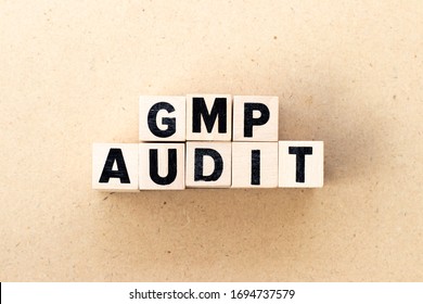 Letter Block In Word GMP (Abbreviation Of Good Manufacturing Practice) Audit On Wood Background