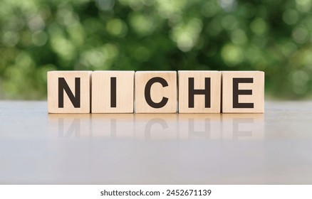 Letter block in word niche on wood background